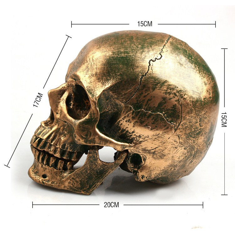 Calavera de resina decorativa dorada