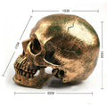 Calavera de resina decorativa dorada